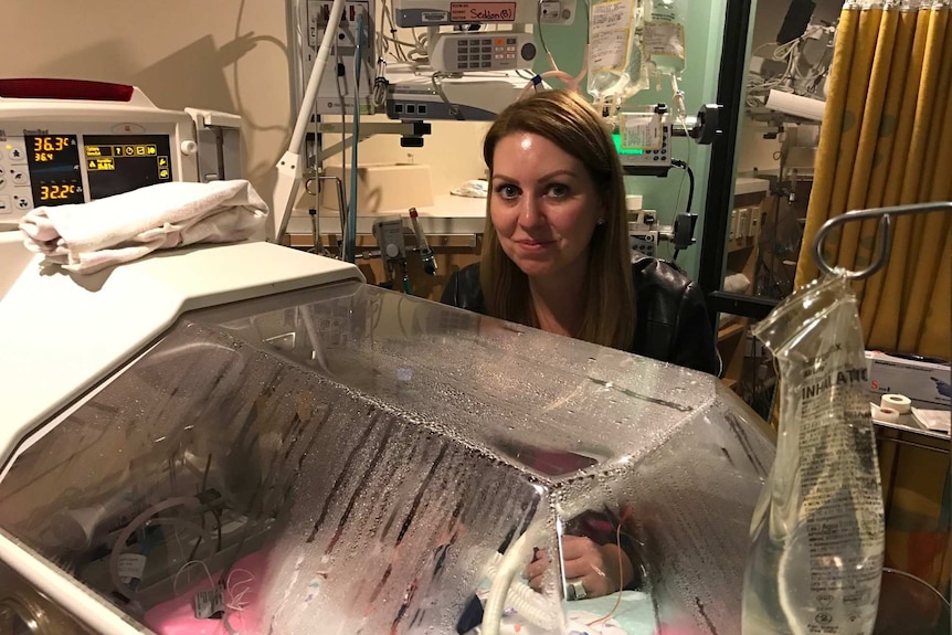 Naomi Seddon with one of her daughters in hospital.