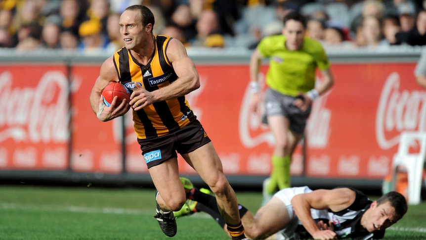 Hawthorn's Brad Sewell wins the ball against Collingwood's Clinton Young at the MCG in June 2014.