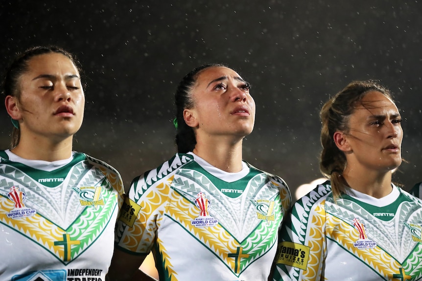 Cook Islands player Jazmon Tupou-Witchman cries as she stands with her teammates at the Women's Rugby League World Cup.