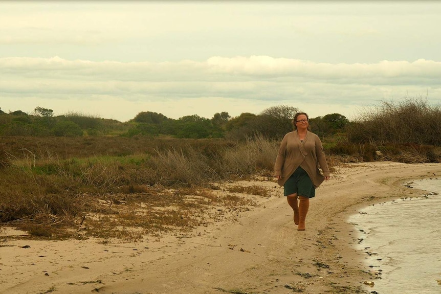 Estaurine ecologist Faith Coleman smiles as she looks toward the water while walking along the shore in the Coorong.