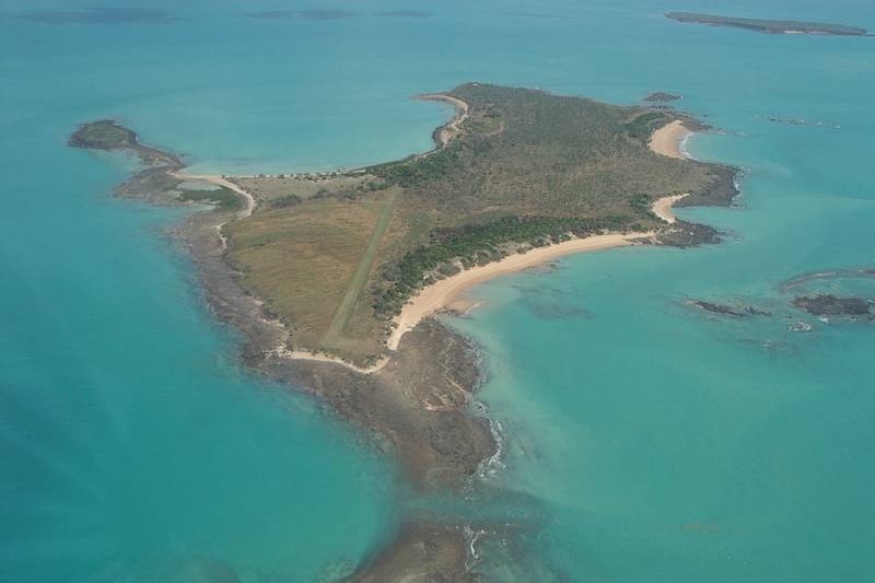 a bird's eye view of an island with sandy and rocky beaches