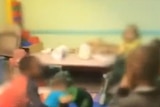 Screenshot from news report showing vision of toddlers punching each other in US daycare centre