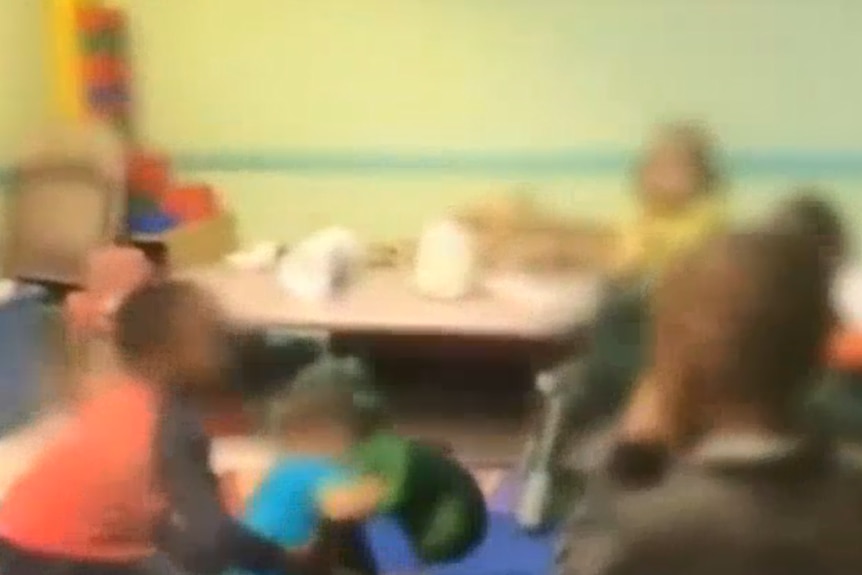 Screenshot from news report showing vision of toddlers punching each other in US daycare centre