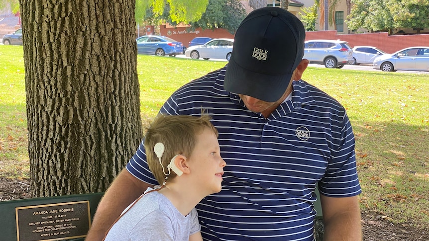 a boy with a cochlear implant and his dad 