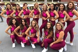 The Brisbane Broncos dance squad in maroon and pink tights and sports bras.