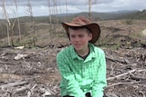 12 year old boy sitting in a clear-felled forest in Lorne, NSW, making a film on new logging laws in Forestry agreement