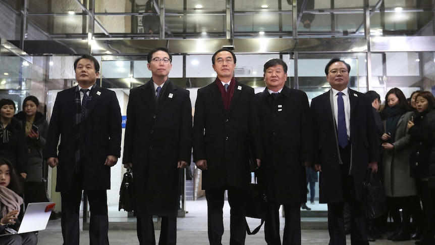 South Korean Unification Minister Cho Myoung-gyon, centre, poses with other delegates