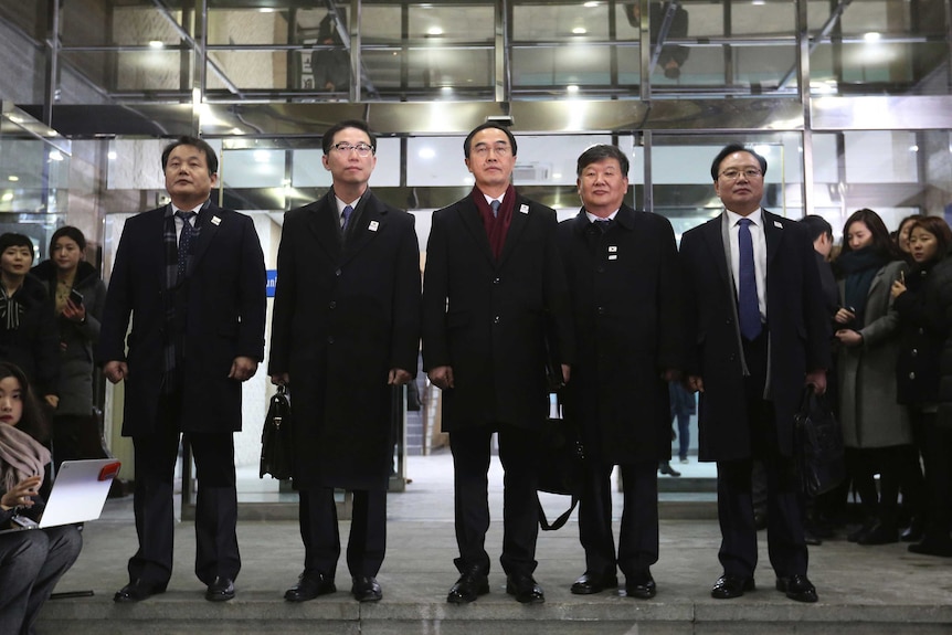 South Korean Unification Minister Cho Myoung-gyon, centre, poses with other delegates