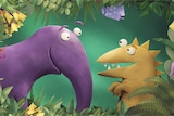 A purple animated dinnosaur with a long trunk smiles at a yellow dinosaur with spikes, surrounded by flowers 