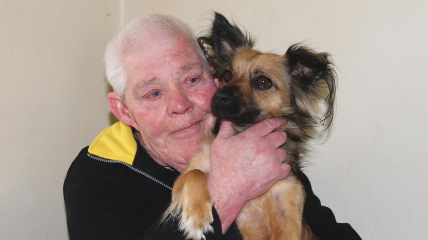 Snowy hugs his dog Poppy.