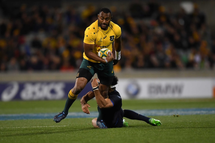 Tevita Kuridrani holds the ball and stands in the tackle of Matias Orlando
