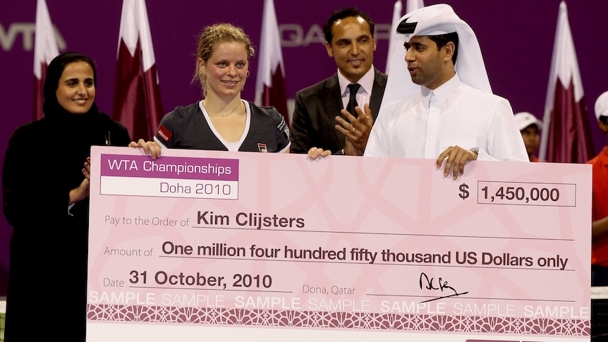 Qatar Tennis Federation President Nasser Ghanim Al Khelaifi presents Kim Clijsters with the winners check