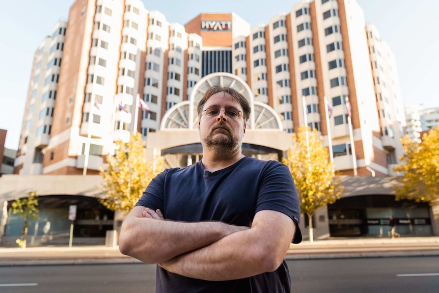 Chris Johnson standing in front of the Hyatt Regency hotel