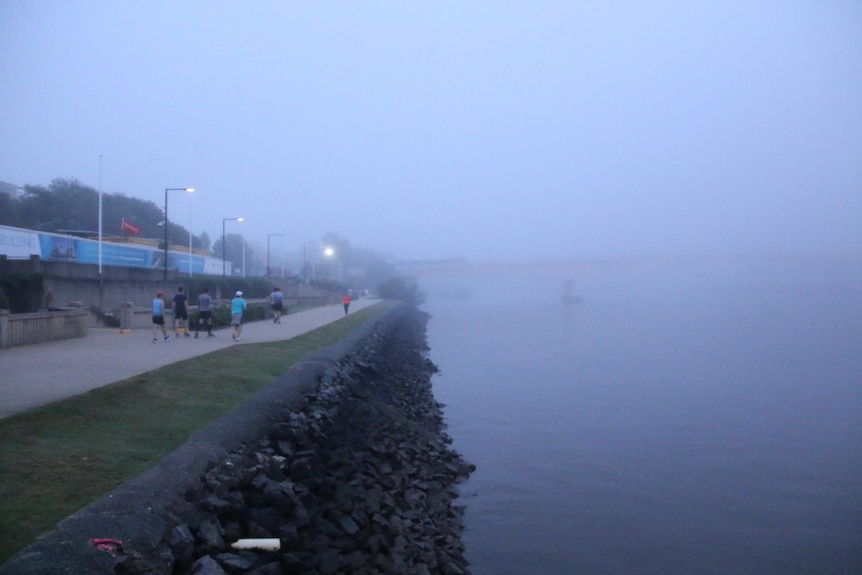 Victoria Bridge hidden in fog from South Bank