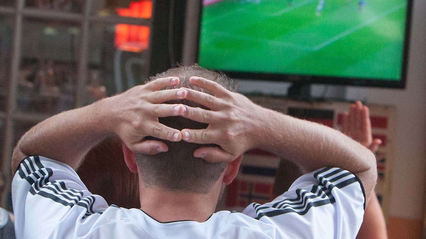 A football fan reacts while watching the FIFA World Cup final between Germany and Argentina.