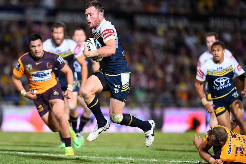 North Queensland's Gavin Cooper makes a break against Brisbane Broncos