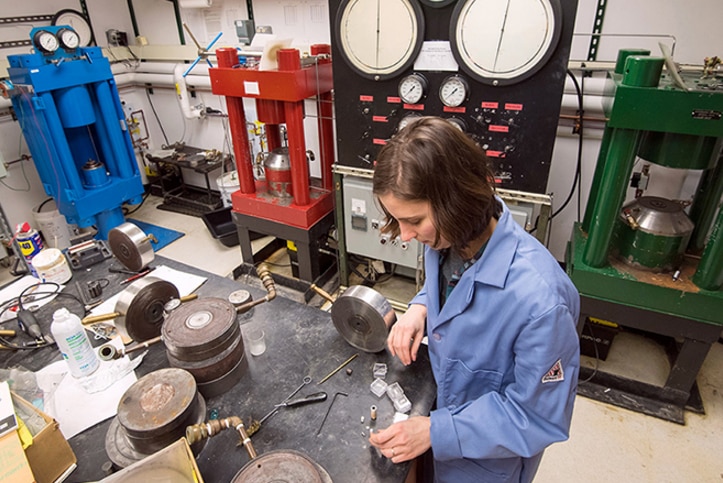Researcher conducting experiment using stainless steel plates.