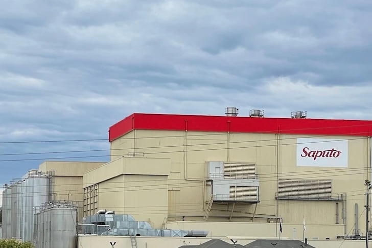 A factory with a red roof and Saputo written on the side.