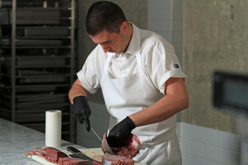 Josh Niland chops up a large fish.