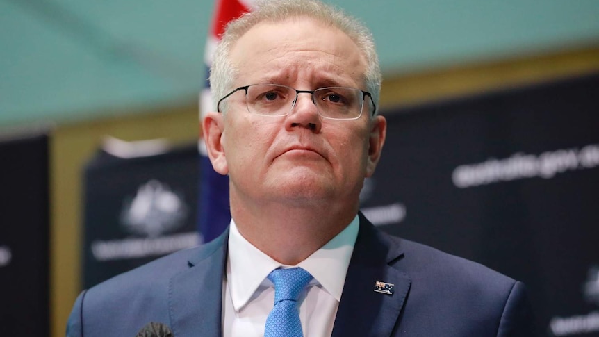 Scott Morrison in front of Government branding.