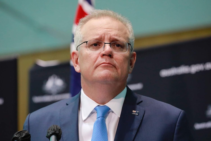 Scott Morrison in front of Government branding.