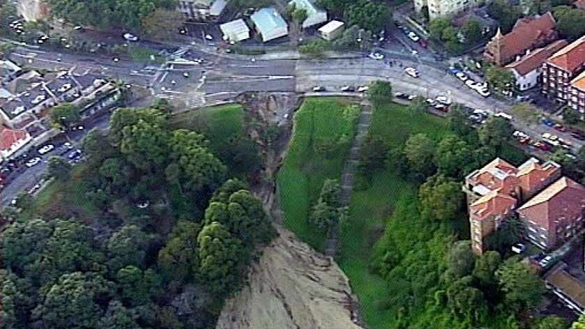 Earth sits beneath a 25 metre wide crater left in Bellevue and Victoria Roads at Bellevue Hill