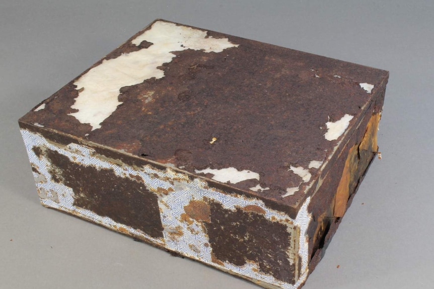 hundred-year-old rusted fruitcake tin