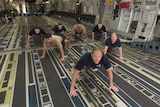 Air Force personnel doing push-ups to raise awareness of veteran suicide