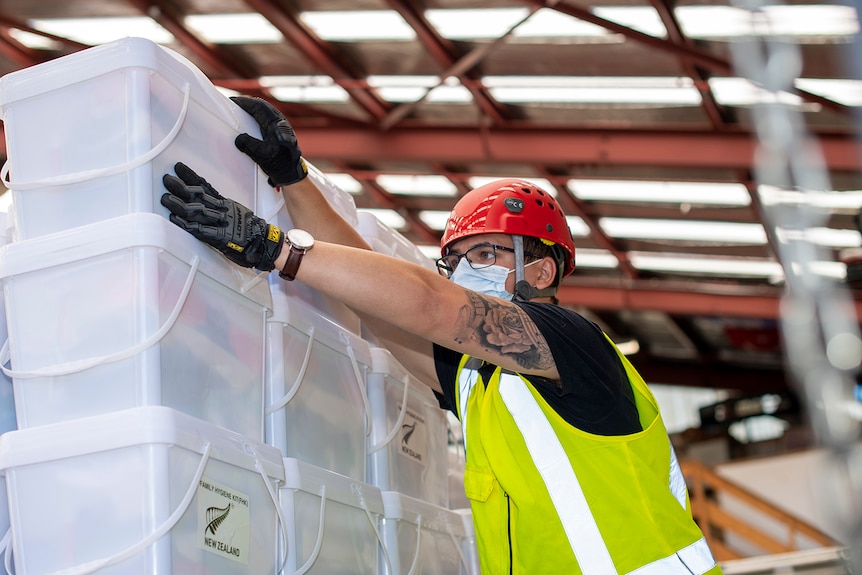 Boxes of aid to Tonga being stacked