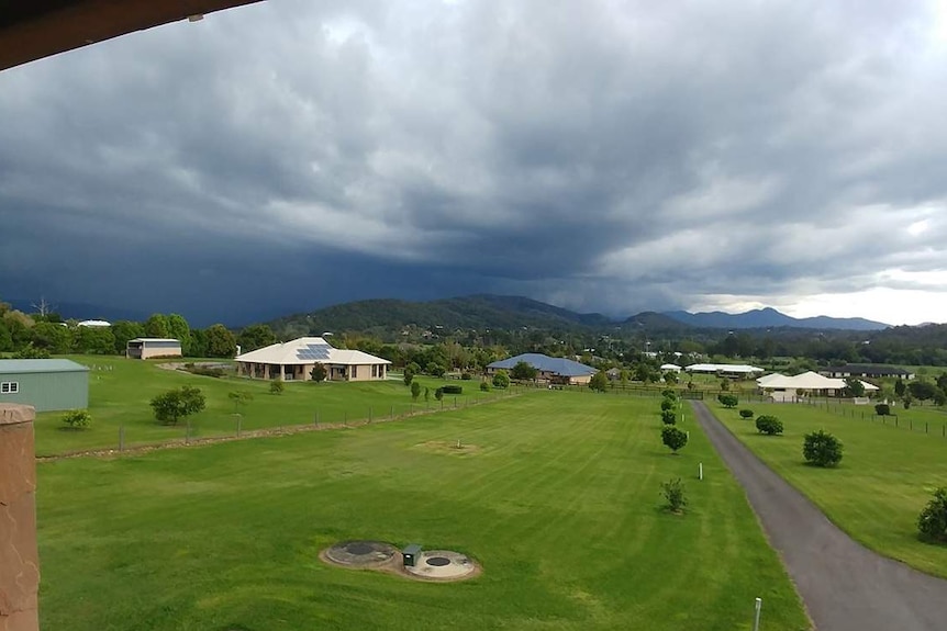 Storm clouds over house at rural properties at Samford, north of Brisbane.