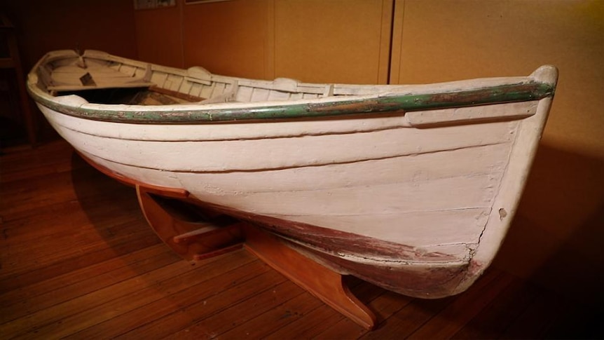 A wooden row boat in a museum