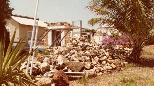 An old colour photo of a destroyed town hall