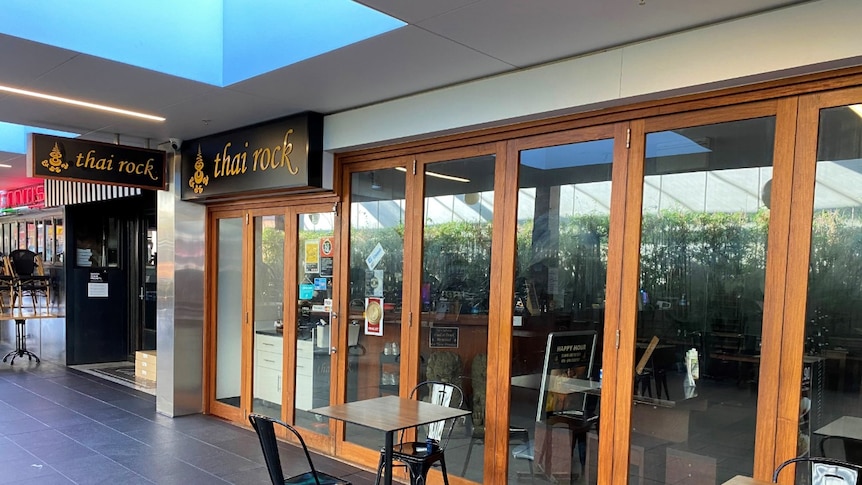 The closed facade of a shop with a sign that says "Thai Rock".