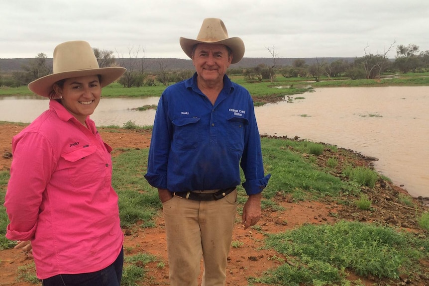 Joella and Wally Klein in front of the full dam on Orange Creek station in Central Australia.
