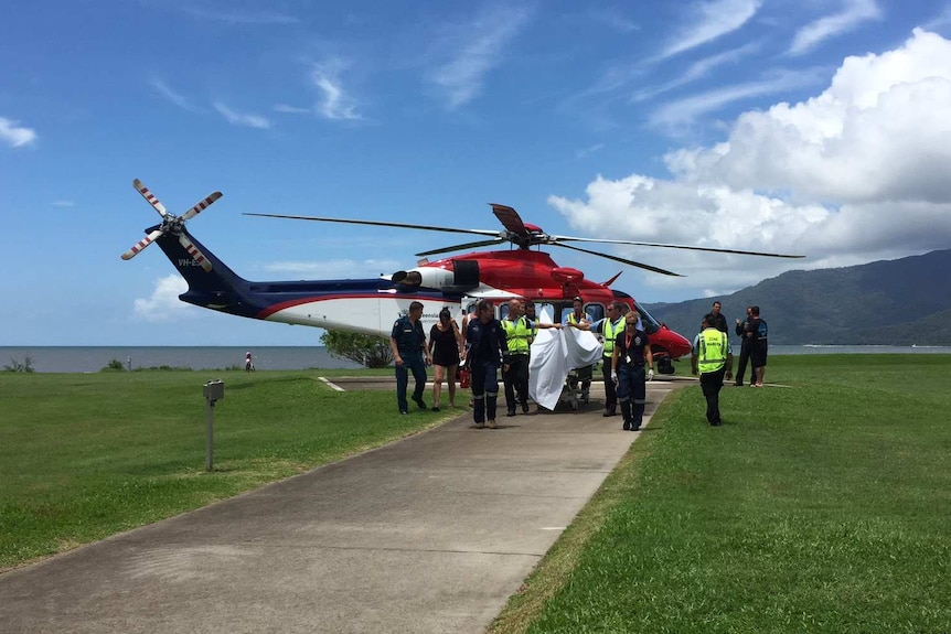 Rescue helicopter carrying man attacked by shark arrives at Cairns Hospital