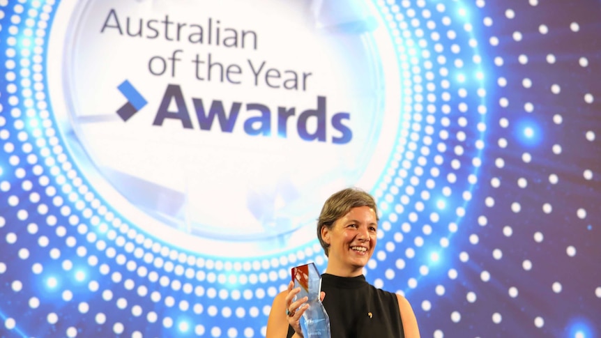 2018 Australian of the Year Professor Michelle Yvonne Simmons on stage holding her award.