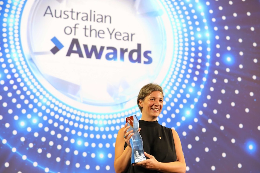 2018 Australian of the Year Professor Michelle Yvonne Simmons on stage holding her award.