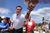 Mitt Romney, with wife Ann (3rd R), hands out his homemade chili
