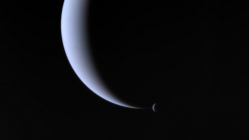 Neptune and its moon Triton, shot by Voyager 2.
