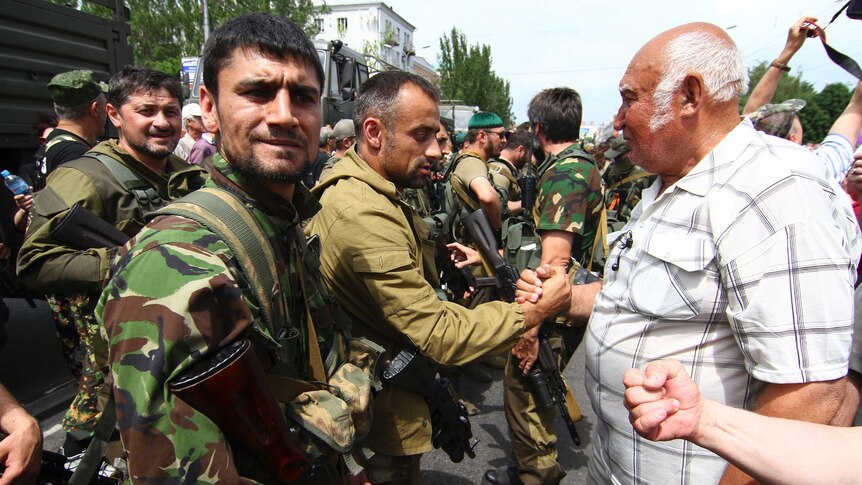 Pro-Russian separatists from the "East" battalions speak with local residents