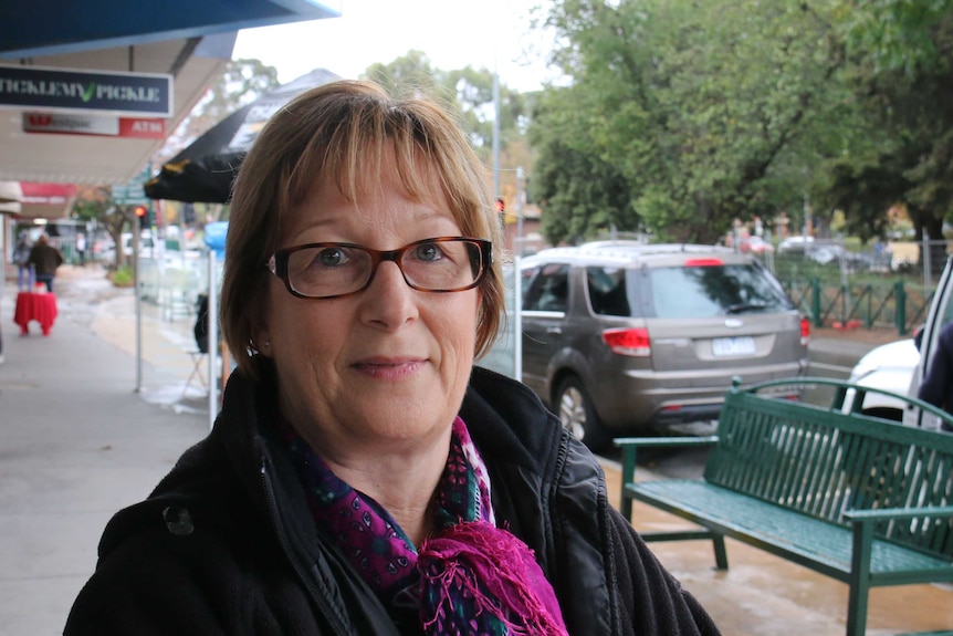 Liz Davies sitting outside shops in Berwick.