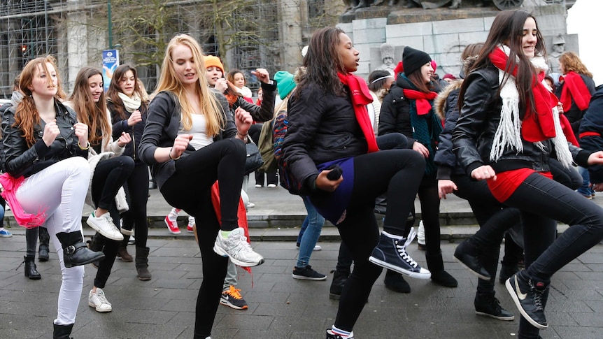 A group of women dance outdoors in Brussels as they take part in the "One Billion Rising" campaign.