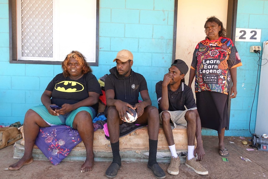 Indigenous man Stephen Briscoe's children and partner out the front of a house.