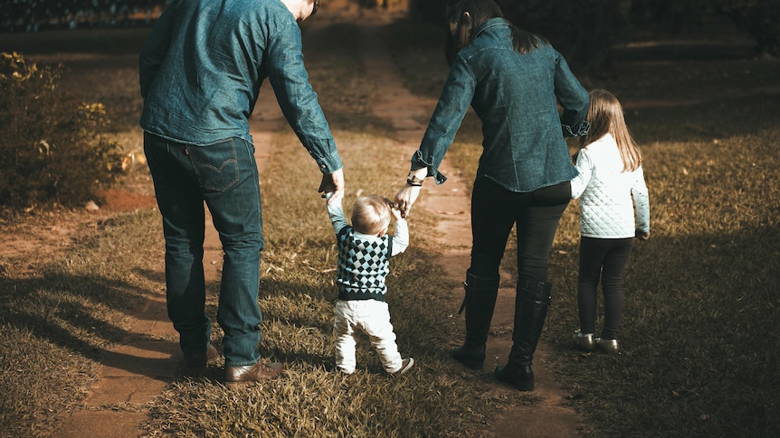 A family walking backwards.