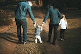 A family walking backwards.