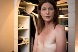 Topless photo of Jeanne Christie looking at the camera after her double mastectomy