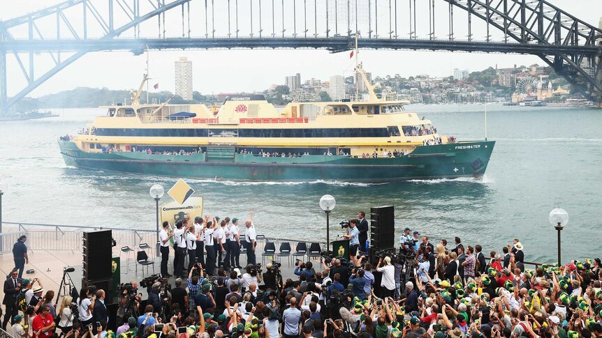 A Manly Ferry passes the Ashes reception at the Sydney Opera House.