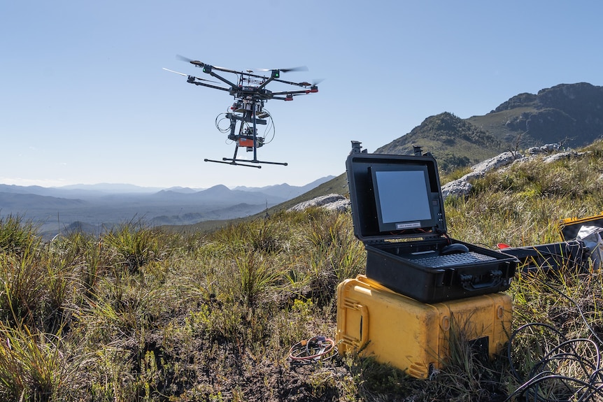 A drone takes off in the wilderness