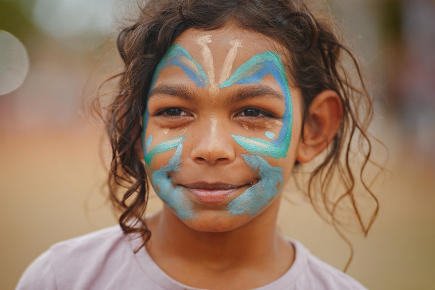 Portrait of a girl with butterfly face paint. 