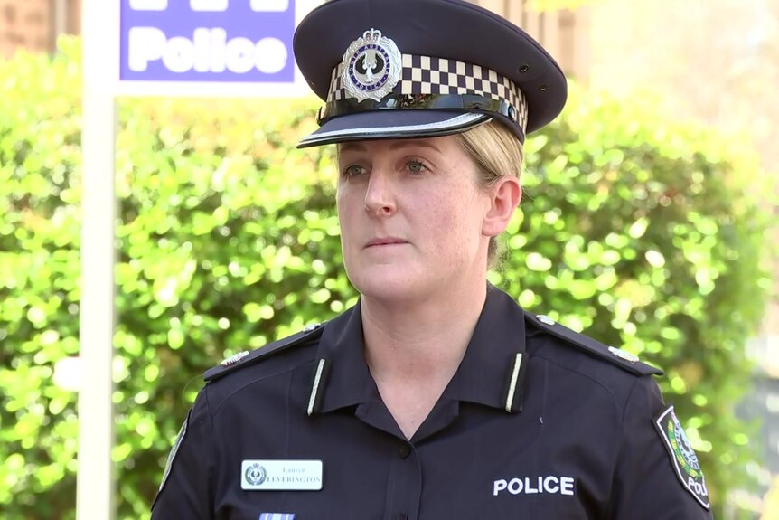 A profile shot of a female police officer wearing her uniform and cap